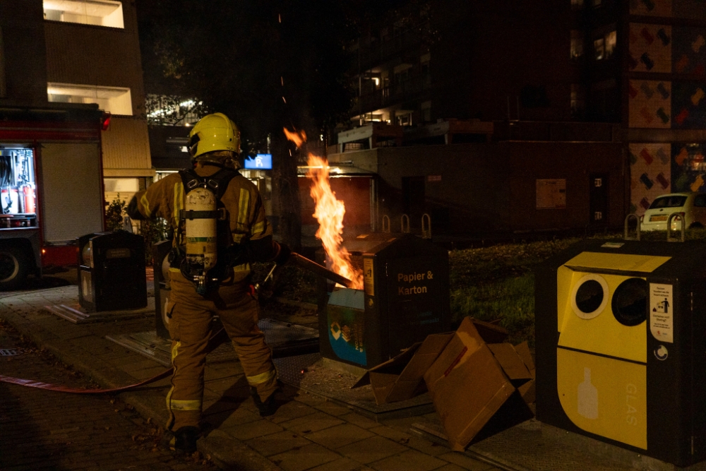 Vlammen slaan uit papiercontainwer in centrum van Vlaardingen