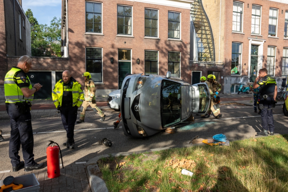 Auto kantelt na botsing met geparkeerde auto op de Nieuwe Haven